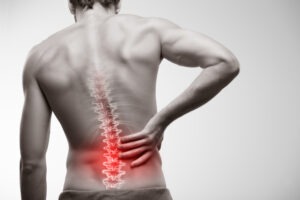 Man with back pain considers consulting a Middletown spine injury lawyer.